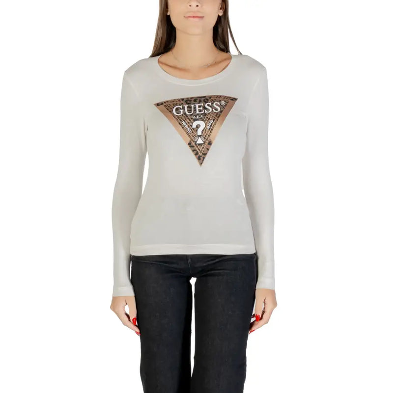 Woman wearing a light gray long-sleeved Guess shirt with metallic triangular logo