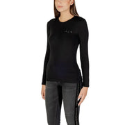 Woman wearing Armani Exchange black long sleeve round neck T shirt with rhinestones and dark grey jeans