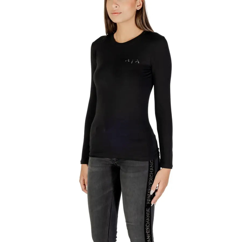 Woman wearing Armani Exchange black long sleeve round neck T shirt with rhinestones and dark grey jeans