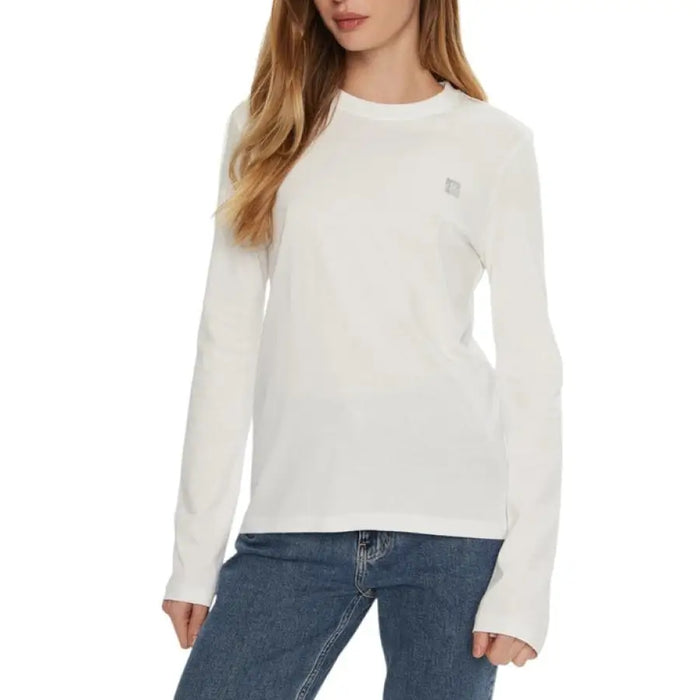 Woman wearing a white long-sleeved shirt as featured in the Black Long Sleeved Shirt product image