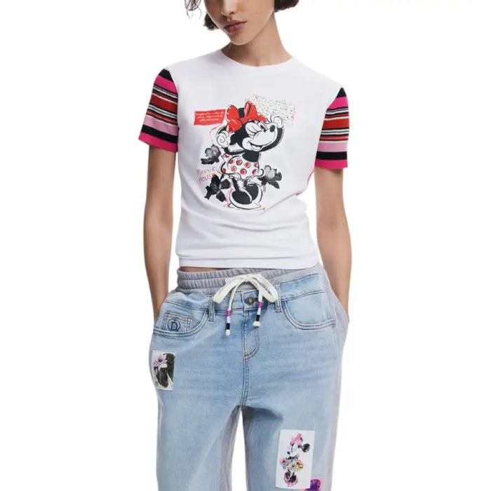 Woman wearing Minnie Mouse graphic tee and patchwork jeans showcasing casual style