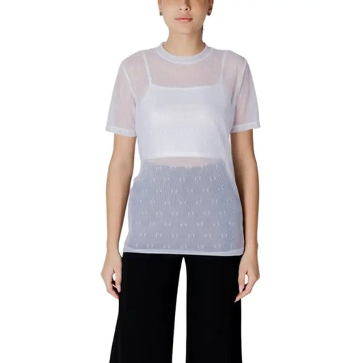 Woman wearing a sheer top with a white tank top underneath in the Women’s Sheer Top with White Tank product image