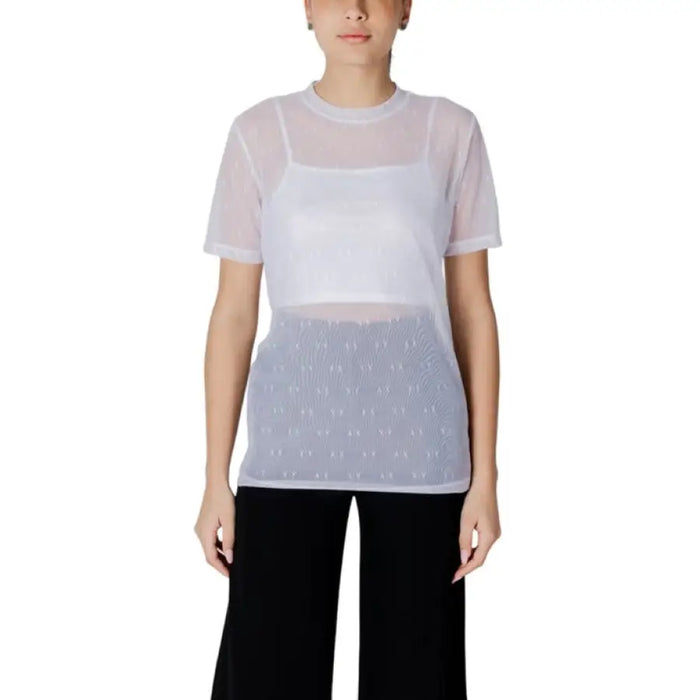 Woman wearing a sheer top with a white tank top underneath in the Women’s Sheer Top with White Tank product image