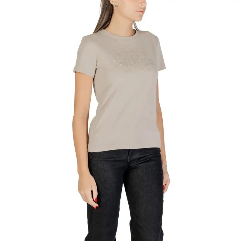 Beige Guess Women Rhinestone Round Neck T-Shirt with short sleeves and dark jeans