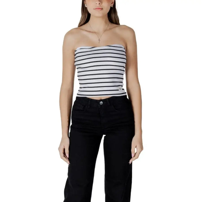 Woman wearing striped tube top and black pants shown in product listing