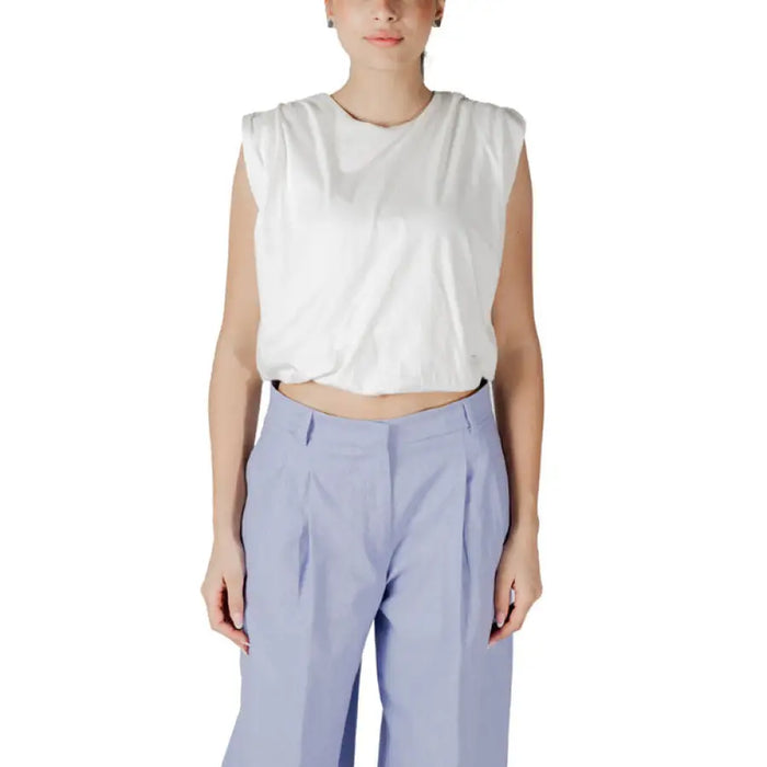 Woman wearing a white crop top and blue pants from the White Crop Top and Blue Pants for Women collection