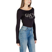 Women wearing black Guess long-sleeved boat neck logo T-shirt with blue jeans