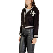 Women’s black cable knit cardigan with white NY emblem and striped trim for fall winter style