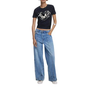 Women wearing Desigual black short-sleeve crop top with white heart graphic and light-wash wide-leg jeans