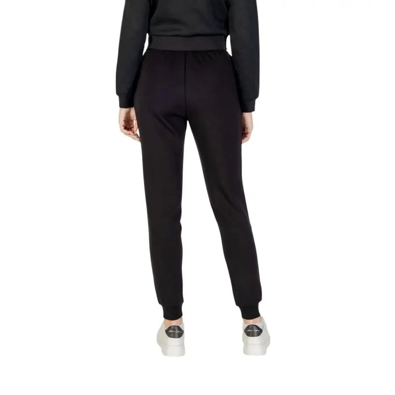Armani Exchange Women Black Laced Fall Winter Trousers paired with white sneakers