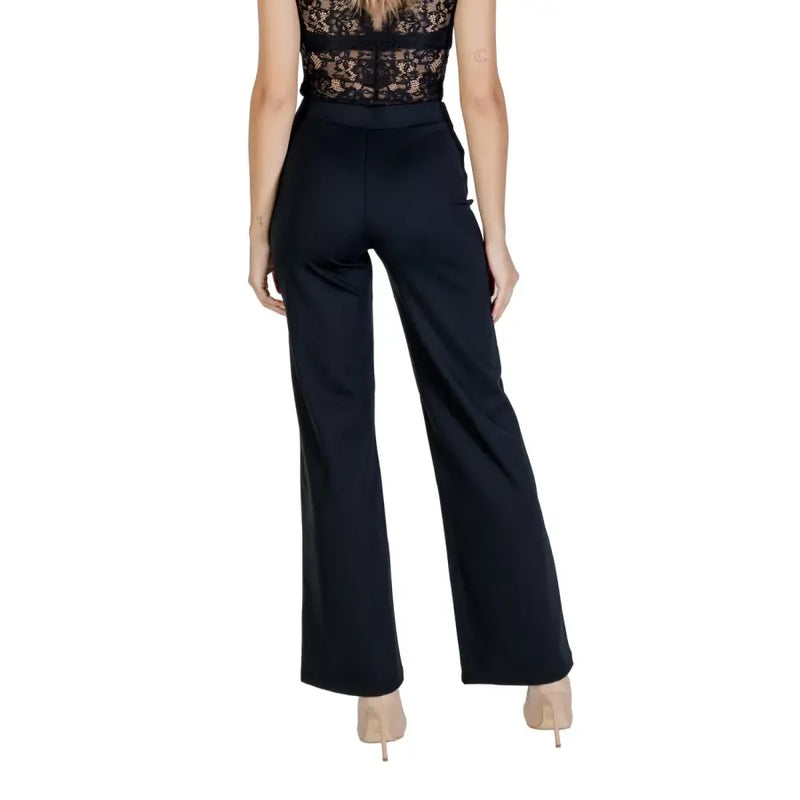 Women wearing Guess Active Fall Winter black high-waist wide-leg trousers with lace top and nude heels