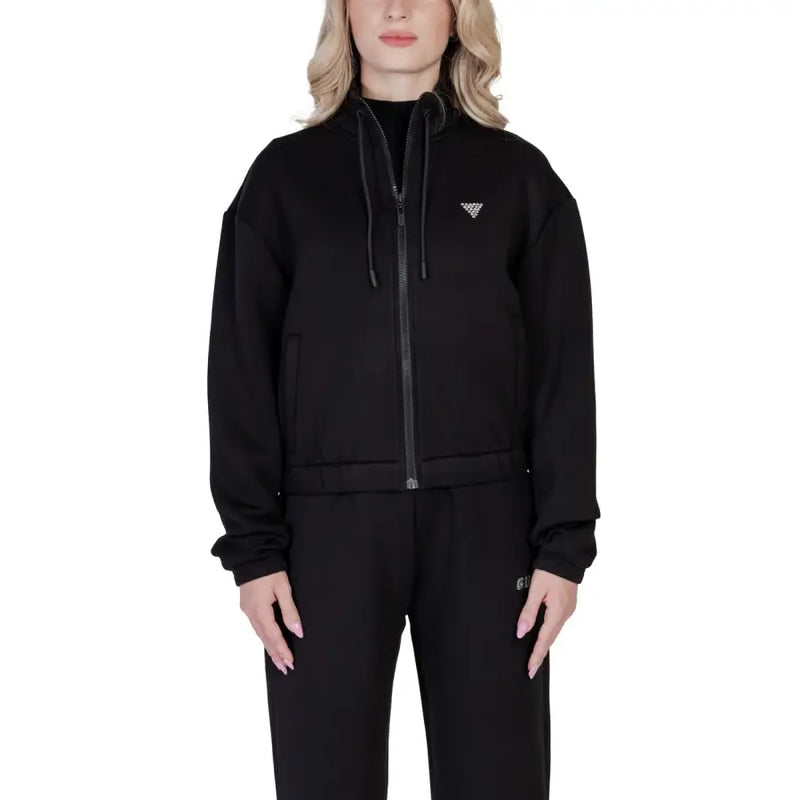 Women’s black zip-up athletic jacket from Guess Active, featuring a hood and sporty design