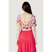 Women’s colorful short-sleeve crop top with square neckline paired with red tiered maxi skirt
