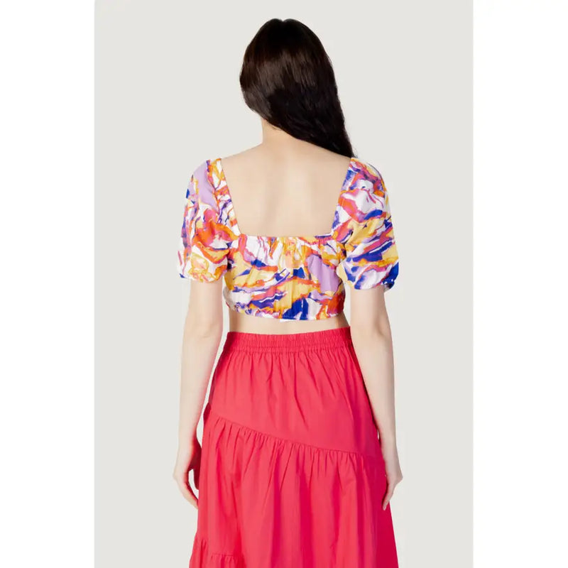 Women’s colorful short-sleeve crop top with square neckline paired with red tiered maxi skirt