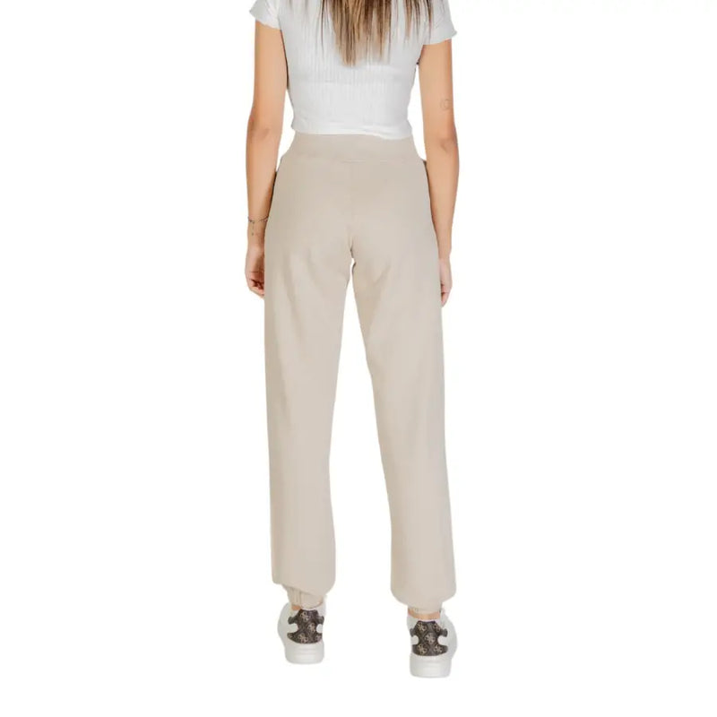 Women’s beige high-waisted cotton trousers with front pockets and elastic cuffs