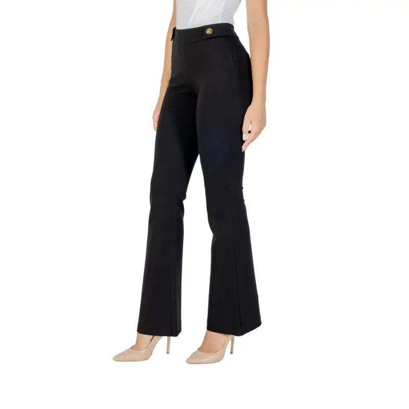 Women’s high-waisted black flare trousers with gold buttons from Guess for fall winter style