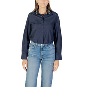 Women’s navy blue long sleeve shirt with embellished collar and light wash wide-leg jeans