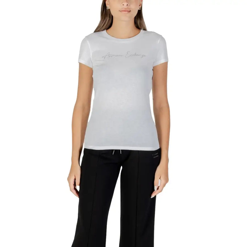 Women’s white short-sleeve cotton T-shirt paired with black athletic pants, stylish and comfortable