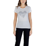 Women’s white short-sleeve T-shirt with silver heart design paired with black pants