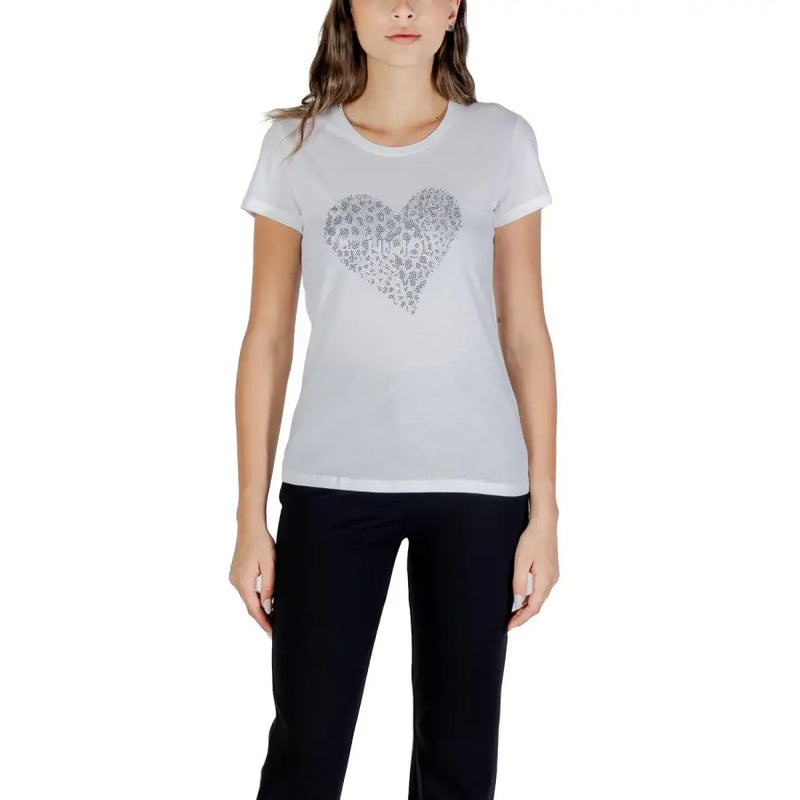 Women’s white short-sleeve T-shirt with silver heart design paired with black pants
