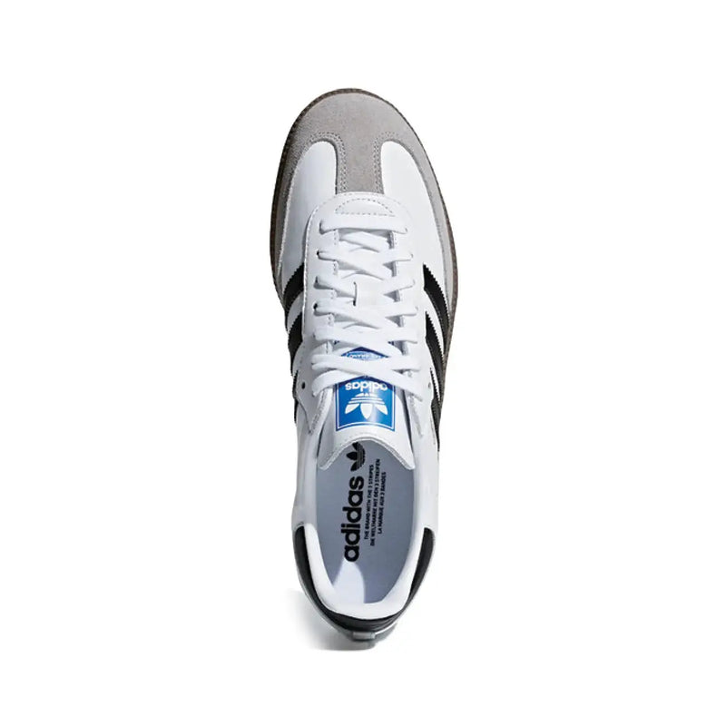 White adidas samba leather sneaker with black three stripes gray suede toe cap heel tab and blue adidas logo on tongue