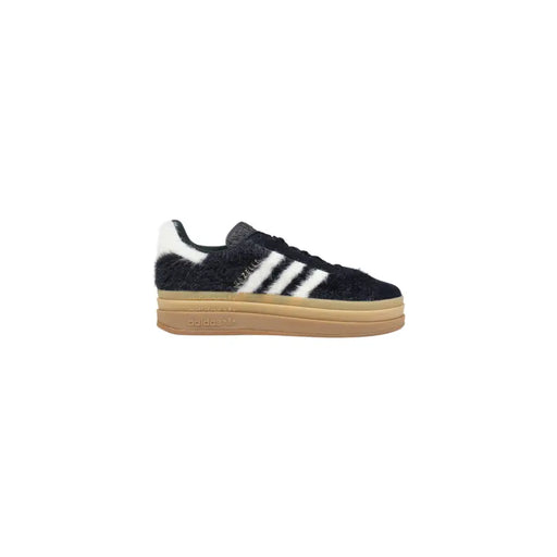 Black fuzzy suede Adidas Campus sneakers with white stripes and tan gum sole