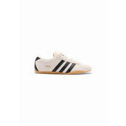 Cream-colored adidas originals women suede sneakers with black three stripes and a gum rubber sole