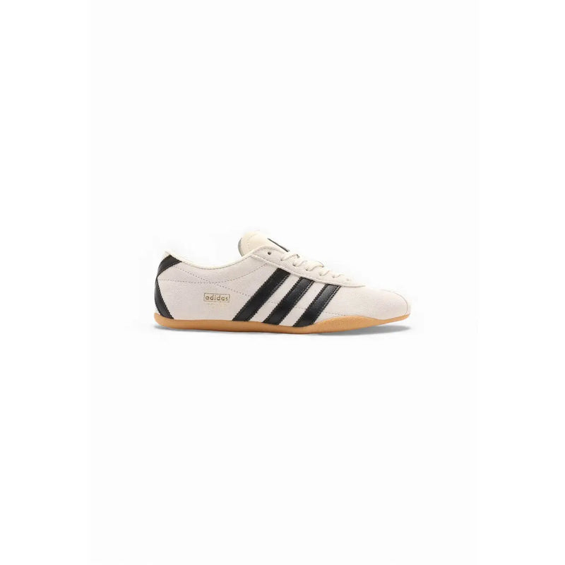 Cream-colored adidas originals women suede sneakers with black three stripes and a gum rubber sole