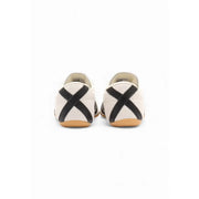 Adidas Originals women’s suede sneakers in white with cream canvas, black cross straps, and tan rubber sole