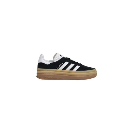 Black Adidas Gazelle suede slip-on sneakers with white stripes, tan sole