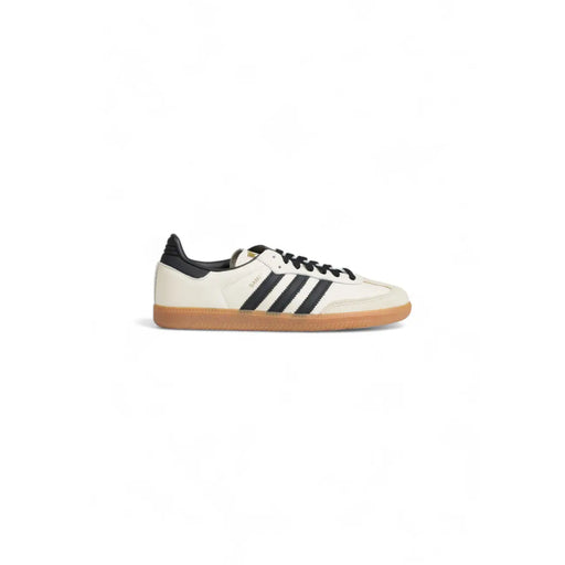 Baskets adidas Samba en cuir couleur crème pour femme, avec trois bandes noires, lacets, languette au talon et semelle en gomme.