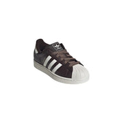 Adidas women leather superstar sneaker in dark brown suede with white three stripes and textured rubber toe cap