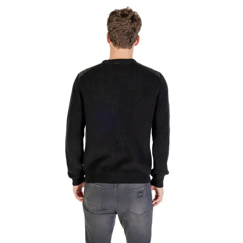 Black ribbed crew neck sweater with a subtle sheen, likely made of cotton or polyester blend.
