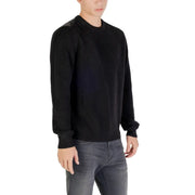 Black ribbed sweater with long sleeves and crew neck.