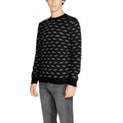 Black and gray geometric patterned sweater with ribbed cuffs and hem, likely made of cotton or wool.