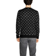 Black and gray geometric patterned sweater with ribbed cuffs and hem.