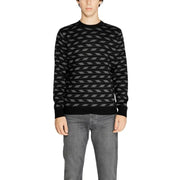Black and gray geometric patterned sweater with ribbed cuffs and hem.