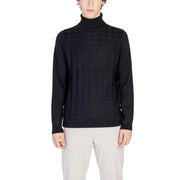 Black turtleneck sweater with geometric pattern and ribbed cuffs, likely made of wool or cotton blend.