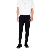 Men’s white short-sleeved T-shirt and black slim-fit trousers with chunky shoes
