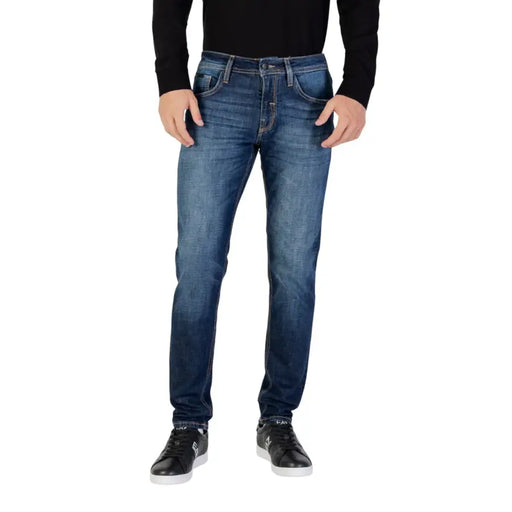 Dark blue denim jeans with a slim fit and distressed details.
