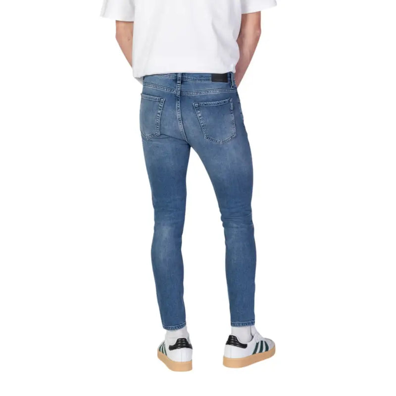 Back view of antony morato light blue slim fit denim jeans with faded wash classic pockets and black waistband