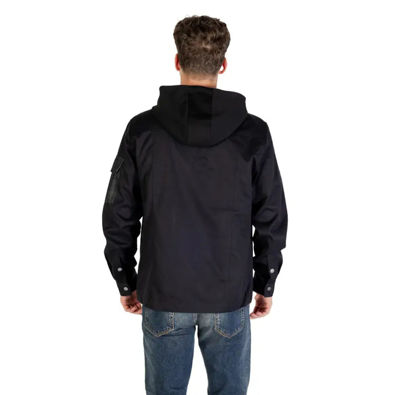 Men’s black hooded blazer with front pockets paired with blue jeans for a stylish look