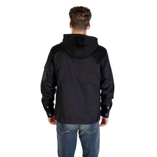 Men’s black hooded blazer with front pockets paired with blue jeans for a stylish look