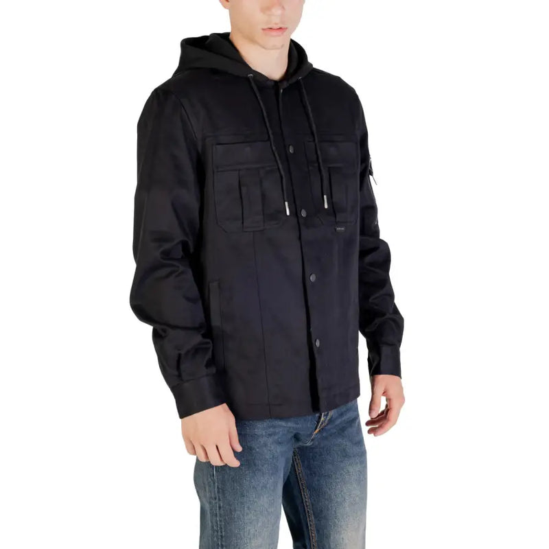 Men’s black hooded utility blazer with front pockets and drawstrings paired with blue jeans