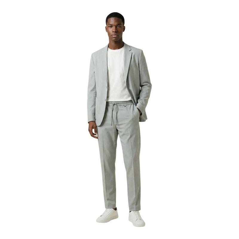 Antony Morato men grey polyester v neck lapel blazer paired with sleek light gray tailored drawstring pants and white sneakers