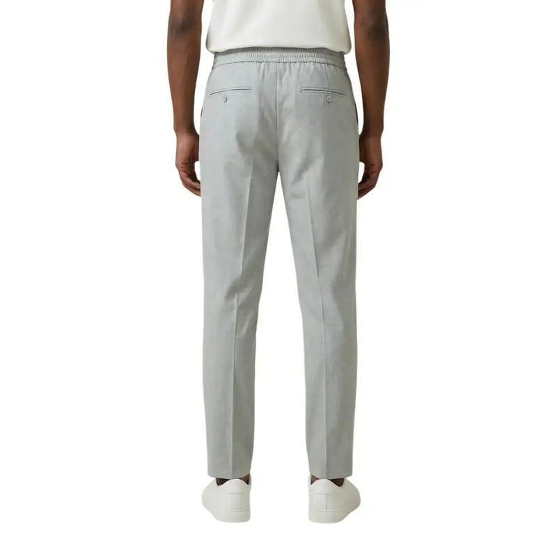 Antony Morato men grey slim-fit polyester viscose trousers with elastic waistband and two back pockets shown from the back side