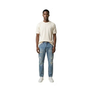 A pair of light-wash distressed denim jeans with ripped details on knees and thighs for Antony Morato men t-shirt collection