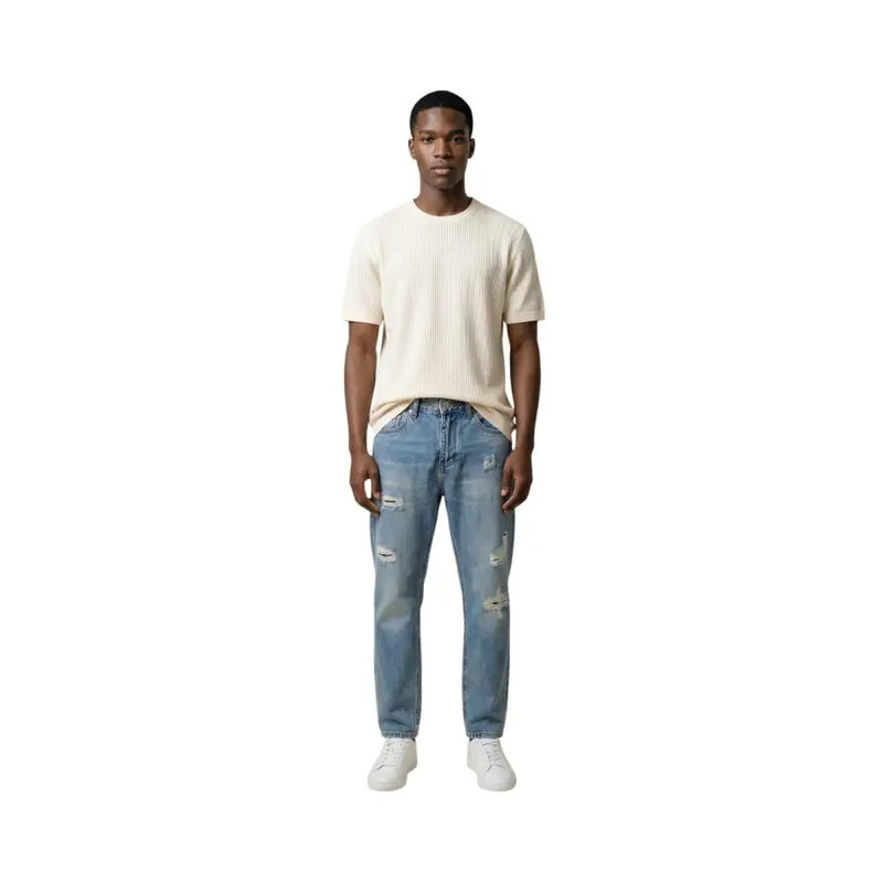 A pair of light-wash distressed denim jeans with ripped details on knees and thighs for Antony Morato men t-shirt collection