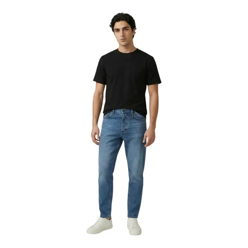 Antony Morato men t-shirt paired with medium-wash blue denim jeans featuring a classic five-pocket design and straight-leg cut