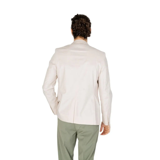 A man wearing an antony morato men white cotton blend blazer in cream with tailored fit and subtle stitching details